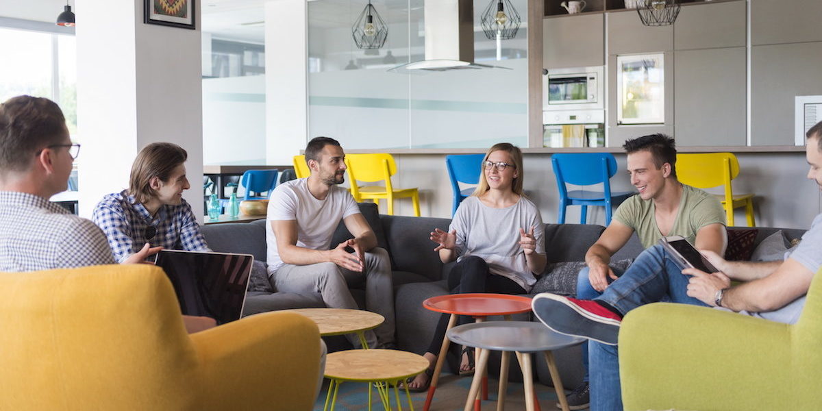 Employees engaged in a brainstorming session in a comfortable work setting