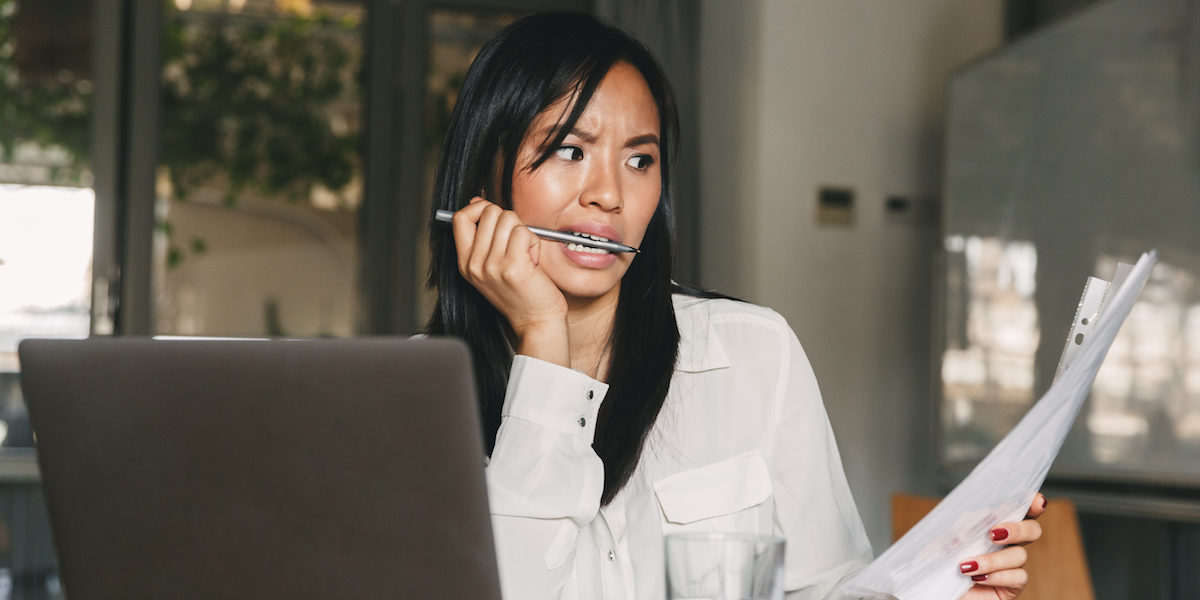 Woman at work registering for employee benefits and confused over all the insurance terms she’s coming across