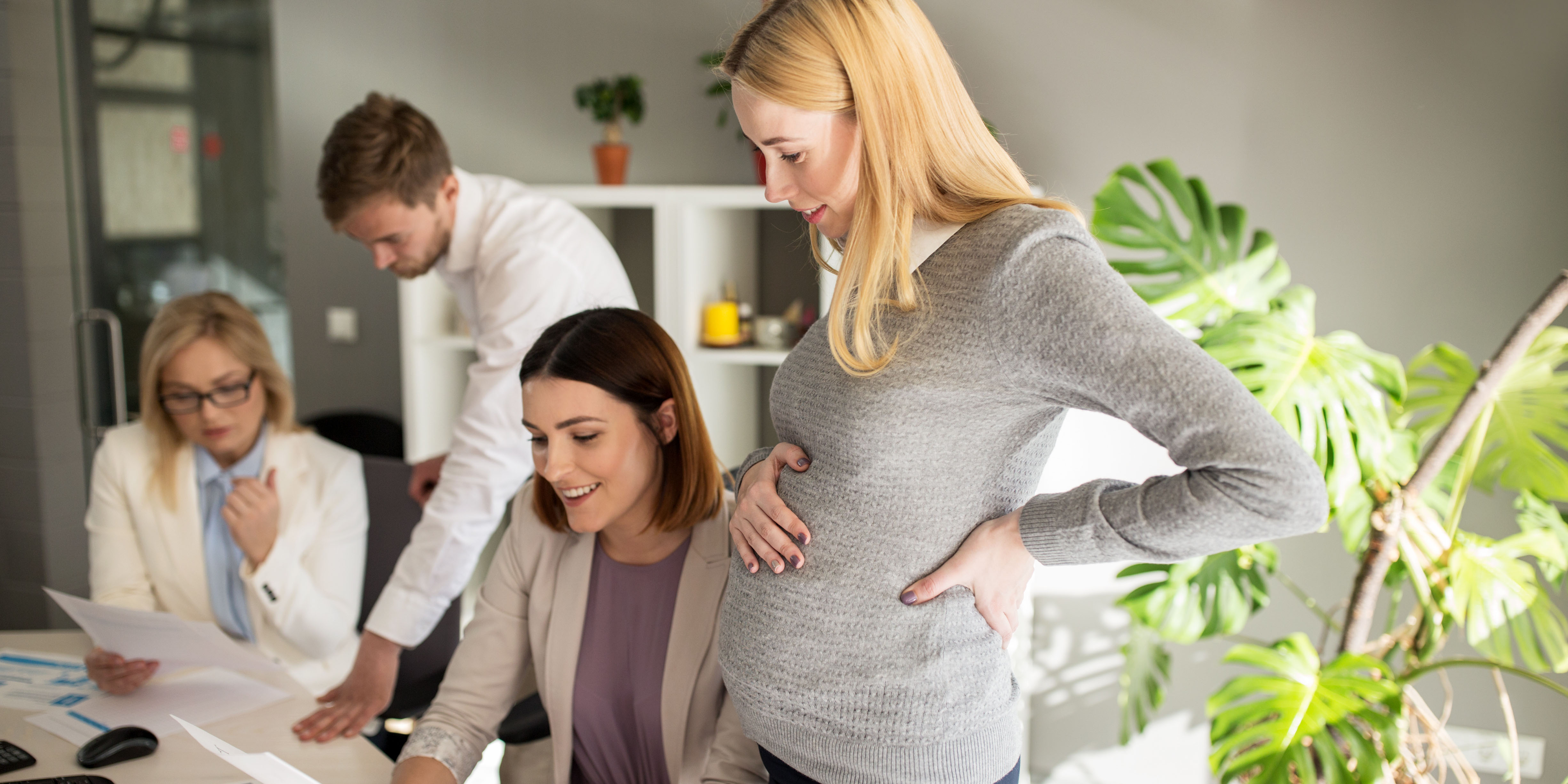 Pregnant employee with coworkers