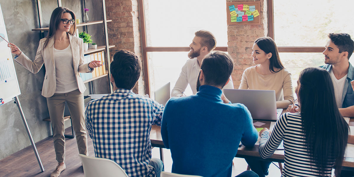 Woman introducing employee benefits to a small group